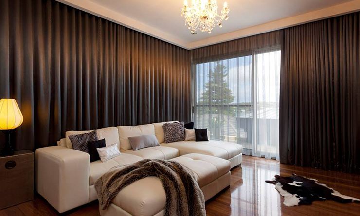 Chocolate blockout curtains open at the window with sheers drawn behind
